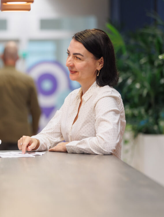 two ladies at a desk looking to screen left